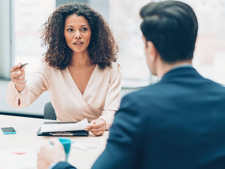 Woman expressing an idea to a man sitting across from her.